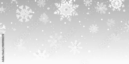 Falling snowflakes and winter trees against a soft blurred grey background