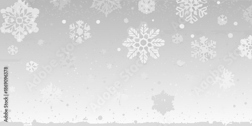 Delicate white snowflakes falling against a soft blurry winter background