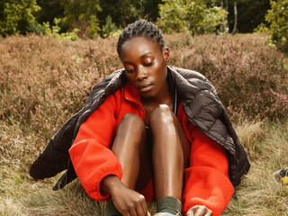 Black Woman Hiking in Red Fleece in Autumn Field