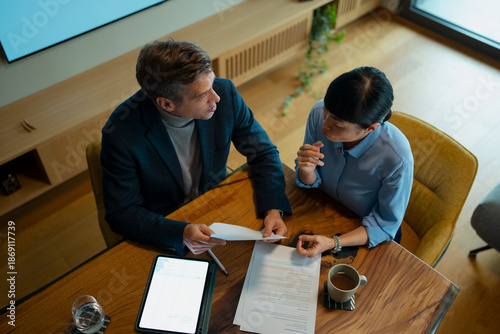 Business professionals discussing contract during an important meeting