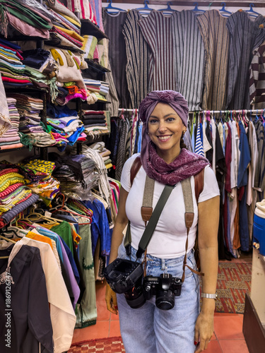Woman wearing turban inside Moroccan fabric shop