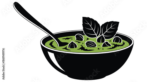 A vibrant green soup with a mint garnish presented as a silhouette