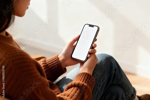 Person using smartphone indoors