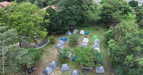 Aerial view of idyllic camping and lodging area offering a quiet getaway surrounded by lush trees