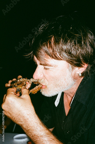 gnawing on a rib bone after the barbecue