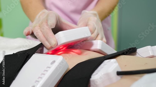 Lipo laser equipment on female body in medicine salon or modern beauty clinic. Body care. Fast fat burning. wellness center with weight loss procedures. 4 k video