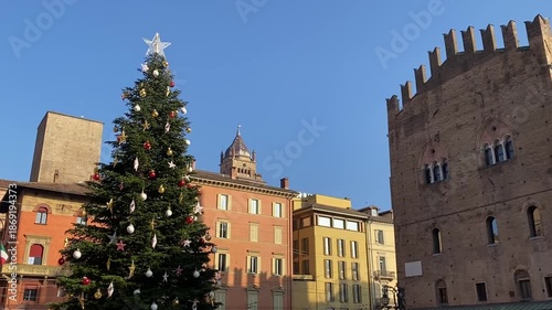 Wallpaper Mural Festive christmas tree adorned with golden and red ornaments standing in a historic italian city square of Bologna. Torontodigital.ca