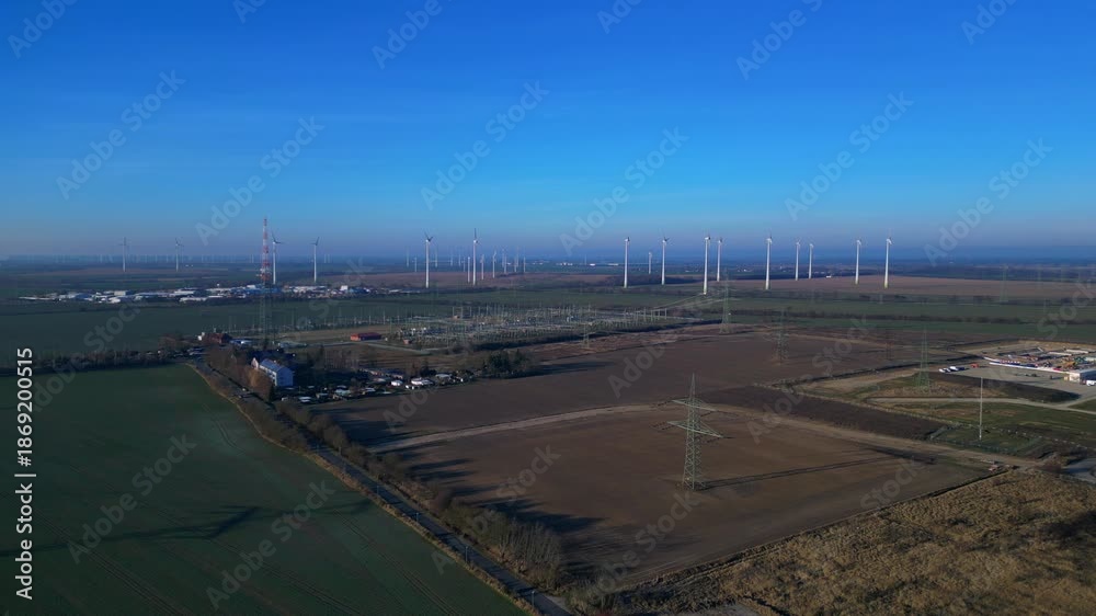 custom made wallpaper toronto digitalwind turbines generating clean energy, linked to a power substation and high voltage power lines. Unique aerial view drone shot from above