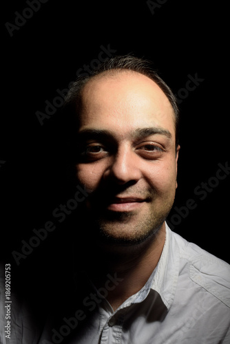 Wallpaper Mural Portrait of an Iranian man with a simple smile on a black background Torontodigital.ca