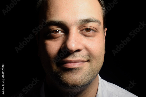 Wallpaper Mural Portrait of an Iranian man with a simple smile on a black background Torontodigital.ca