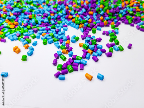 Rainbow polymer granules, yellow masterbatch granules, cold cutting material type, isolated on white background for product catalog design of plastic manufacturing industry company profile