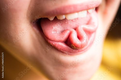 Fotografia Tongue making a playful shape, fun facial expression
