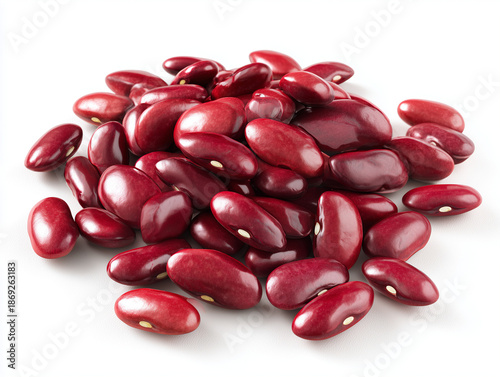 A close-up, high-angle view of a pile of raw, dried red kidney beans (Phaseolus vulgaris) scattered on a plain white background.