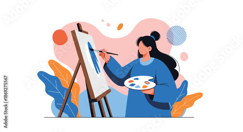 Creative woman in a blue dress painting an abstract work on a canvas with a palette and brush in a colorful studio setting.