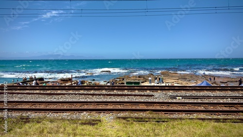 The false bay coastline with train tracks running next to the sea. Dalebrook, Cape Town, South Africa.