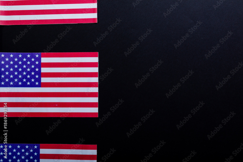 Fototapeta premium Row of usa flags with stars and stripes by copy space on black background