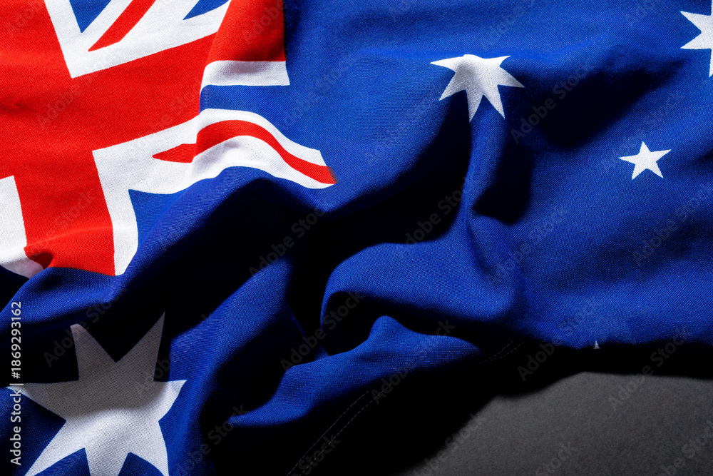 Fototapeta premium Overhead view of australia flag with stars and british union jack over table