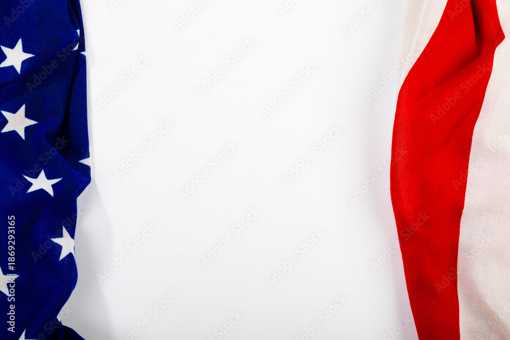 Fototapeta premium Stars on blue fabric near red stripes making them america flag on white background with copy space