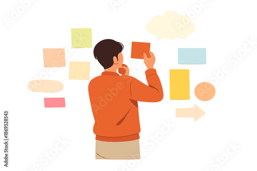 Man arranging colorful sticky notes on a wall