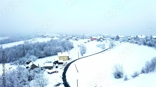 Aerial View of Snowy Rural Village in Bosnia and Herzegovina During Winter