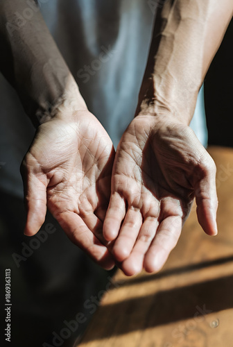 Wallpaper Mural  close-up view of two pairs of hands clasped together, suggesting a gesture of support, comfort, or connection. The hands appear to be intertwined, creating a sense of unity and togetherness. The back Torontodigital.ca
