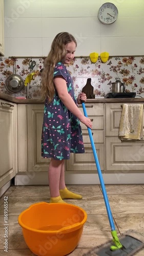 Teenage girl engaged in household chores in the kitchen, tidying up and fulfilling domestic responsibilities. Focused and diligent, she helps maintain a clean and organized home environment. 