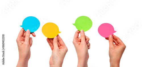 Communication and Dialogue Concept with Four Hands Holding Colorful Speech Bubbles