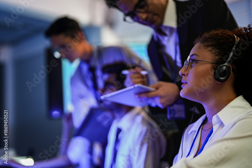 Fotografi Cyber security analysts monitoring network threats in a blue-lit control room