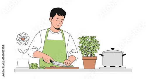 Young man in a green apron carefully chopping ingredients on a cutting board.