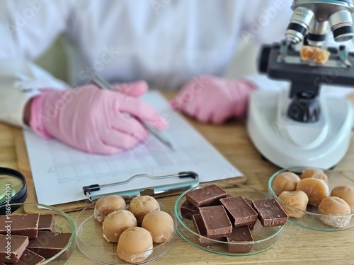 Принти на полотні Examining chocolate samples in a laboratory with a microscope and written notes
