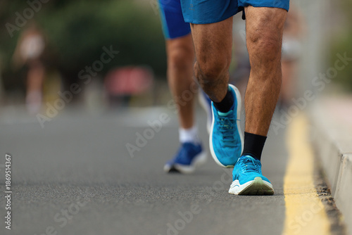 Marathon running race, people feet on city road	