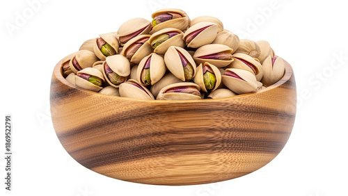 Wooden bowl filled with pistachios on black background