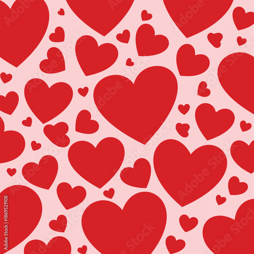 A vibrant pattern of red hearts on a soft pink background for valentines day