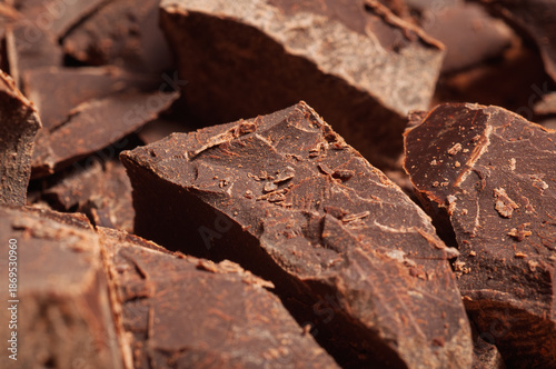 Photography Rich dark chocolate chunks with a textured surface, close-up view