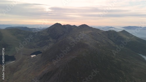 Spectacular 4K aerial video of flying above highest mountain ridge in Ireland - McGillyCuddy Reeks at sunset, with breathtaking views around, Kerry mountains, Ireland