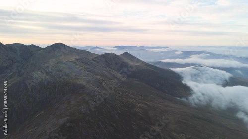 Spectacular 4K aerial video of flying above highest mountain ridge in Ireland - McGillyCuddy Reeks at sunset, with breathtaking views around, Kerry mountains, Ireland