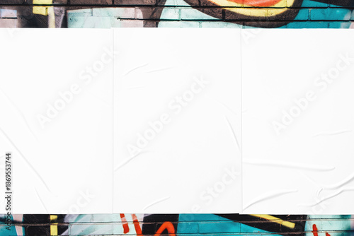 Vászonkép Closeup of colorful messy painted urban wall texture with three wrinkled glued poster templates