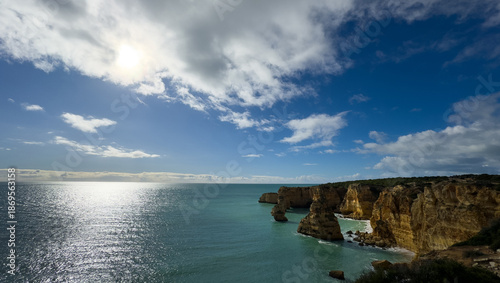 Praia da Marinha, beautiful beach Marinha in Algarve, Portugal. Navy Beach (Praia da Marinha) with flying seagulls over the beach, located on the Atlantic coast in Lagoa Municipality, Algarve.