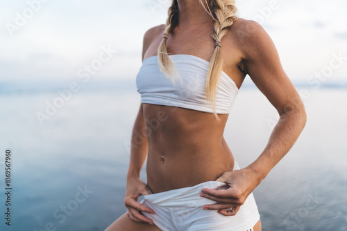 Close-up of athletic woman’s torso, showing toned abs and control, symbolizing discipline, awareness, and empowerment through body strength