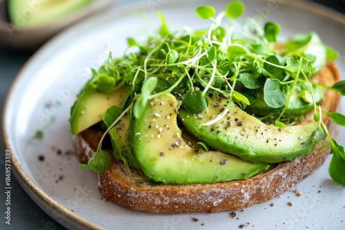 Gourmet avocado toast with microgreens, cress and sesame seeds on dark and light backgrounds