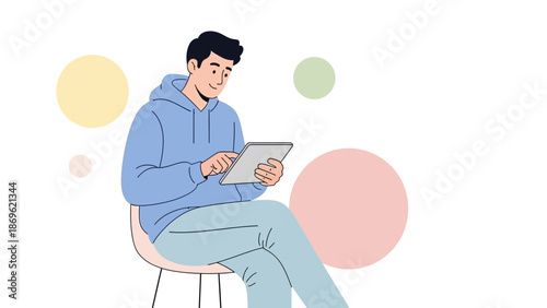 Young man using a tablet computer while sitting, colorful circles background