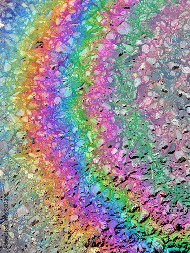 Oil Petrol Rainbow Leak Running over the road tarmac