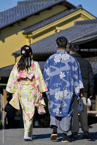 A couple in Japanese national dress walk the streets of Kyoto, Japan
