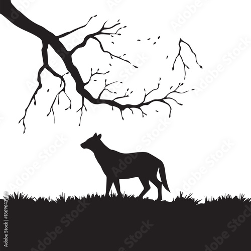 Silhouette of a deer standing beneath branches against a bright background