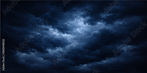 Dramatic dark stormy clouds roll across a blue nature sky during a sunset time lapse creating a moody cloudscape atmosphere with wind and rain