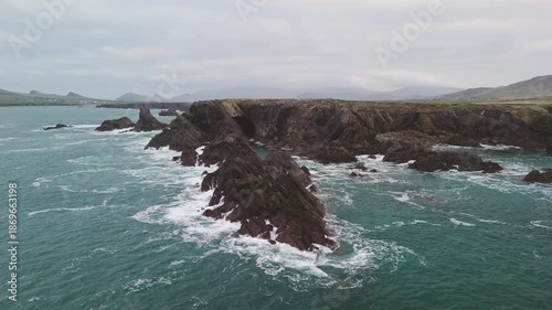 Scenic 4K aerial video of flying above spectacular Atlantic coastline, with picturesque rocks, cliffs and islands, Sybil head, Dingle Peninsula, Kerry, Ireland