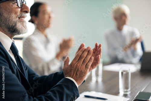 Business people clapping hands in a successful meeting