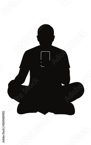 Silhouette of a person meditating while using a smartphone  