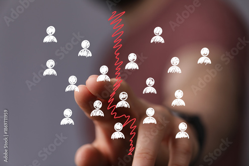 Stock photo of a hand separating groups of people, symbolizing division, conflict, or a business split.