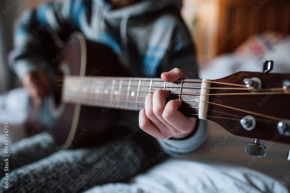 Fototapeta premium White dad jamming on guitar with kids in a bedroom hand gripping the neck